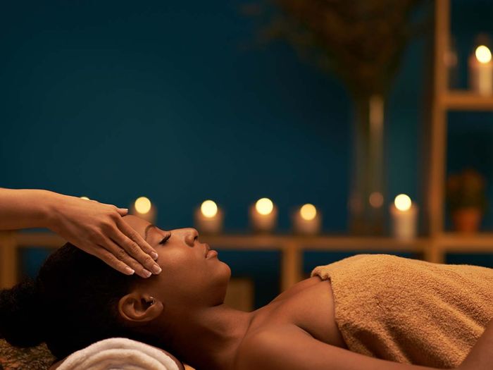 masseuse massaging a woman with hot stones and aromatherapy