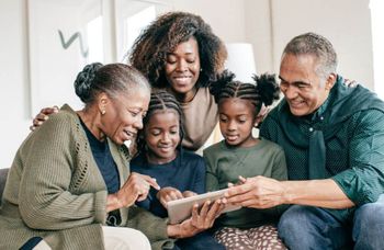 multi-generational family looking at a tablet