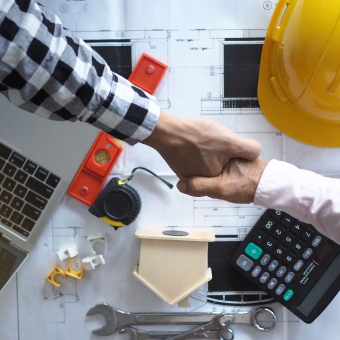 Shaking hands over construction objects