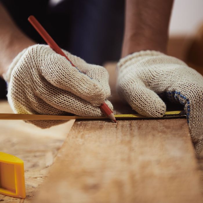 contractor using pencil to mark wood contractor using pencil to mark wood