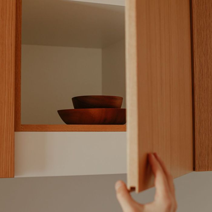 an open kitchen cabinet with bowls What To Consider When Shopping For New Kitchen Cabinets (2).jpg
