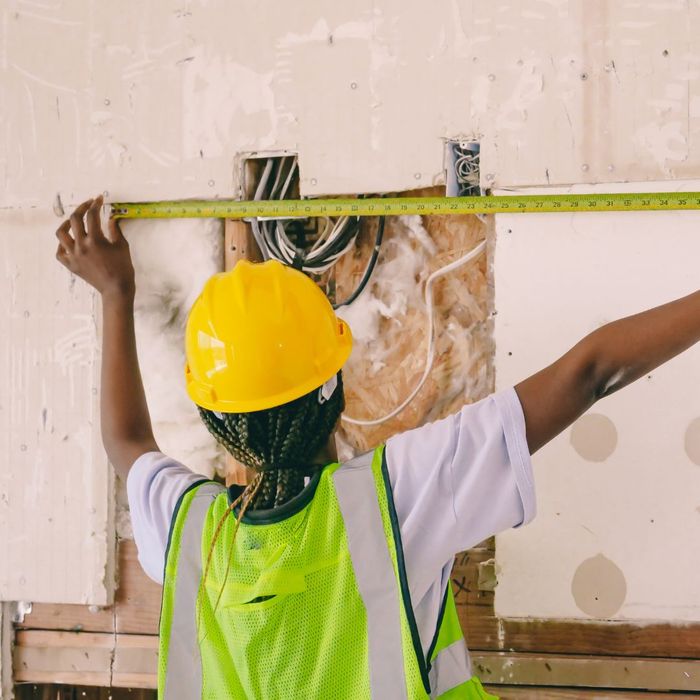 a person measuring a wall 4 Things To Ask Your Home Improvement Contractor (2).jpg