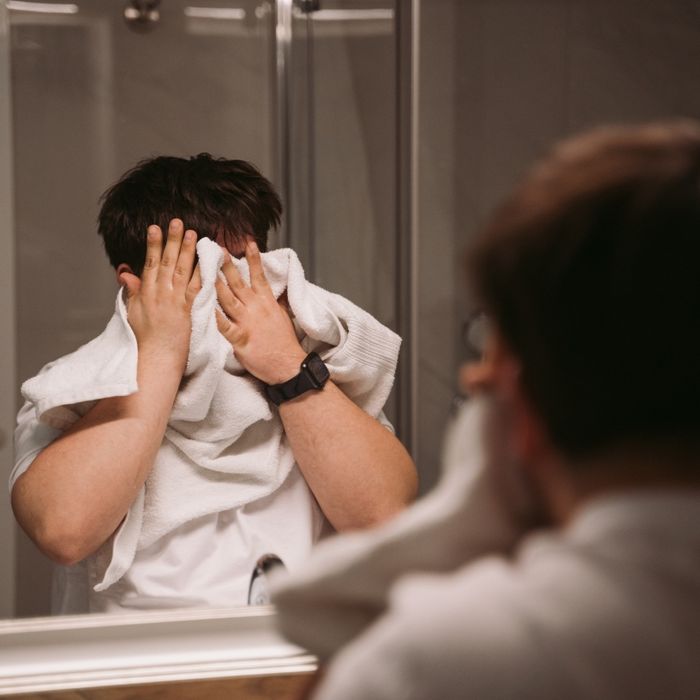 Person drying their face off with a towel