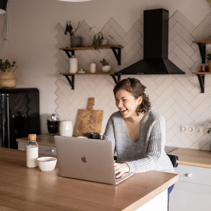 smiling woman using laptop