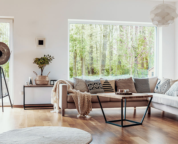 living room interior with large window showing trees in the background