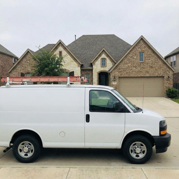 A LoneStar Glass Replacement van is parked in front of a house.