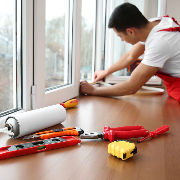 a worker replacing window seals