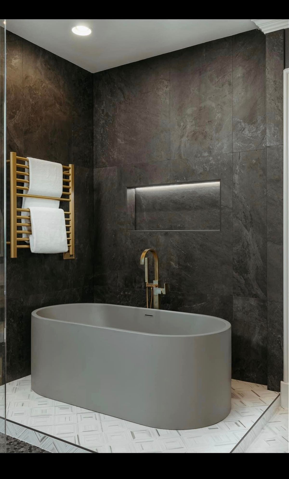 Modern Bathroom with Custom Illuminiche Niche, Freestanding Tub, and Gold Fixtures