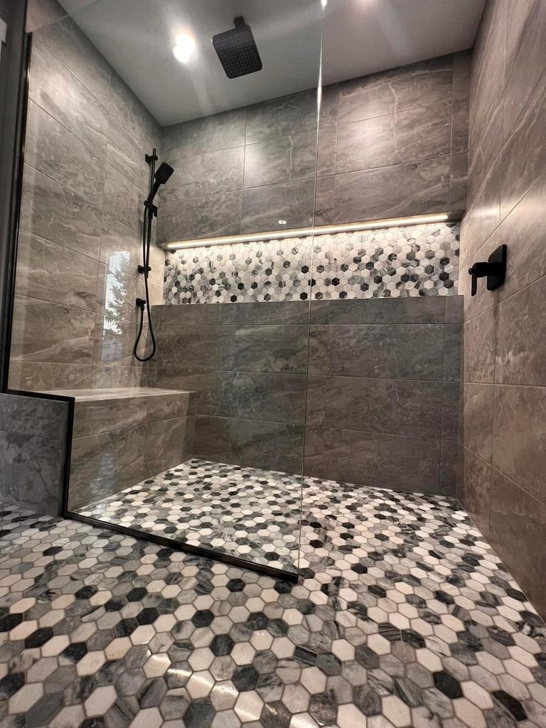 Earth-toned shower with wall-to-wall niche and Illuminiche lighting