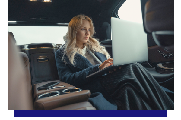 business woman in backseat working