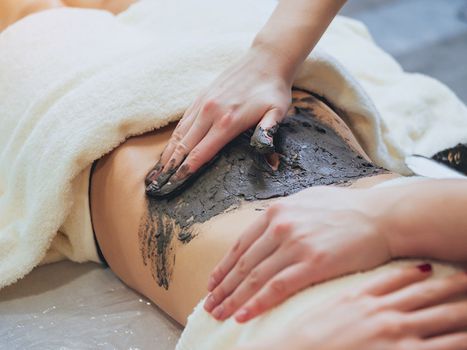 Image of a woman getting a mud treatment