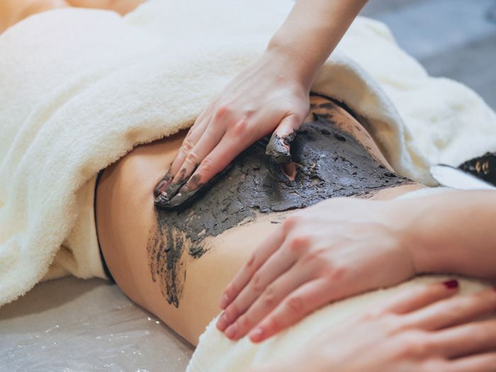 Image of a woman getting a mud treatment