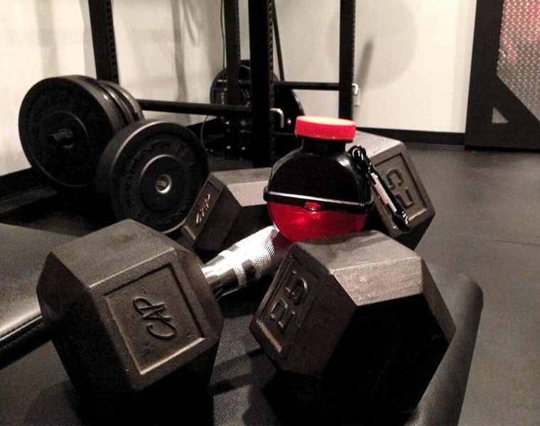 bottle stacked on top of weights