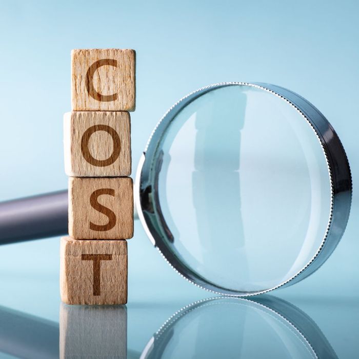 "cost" letter wood blocks and magnify glass
