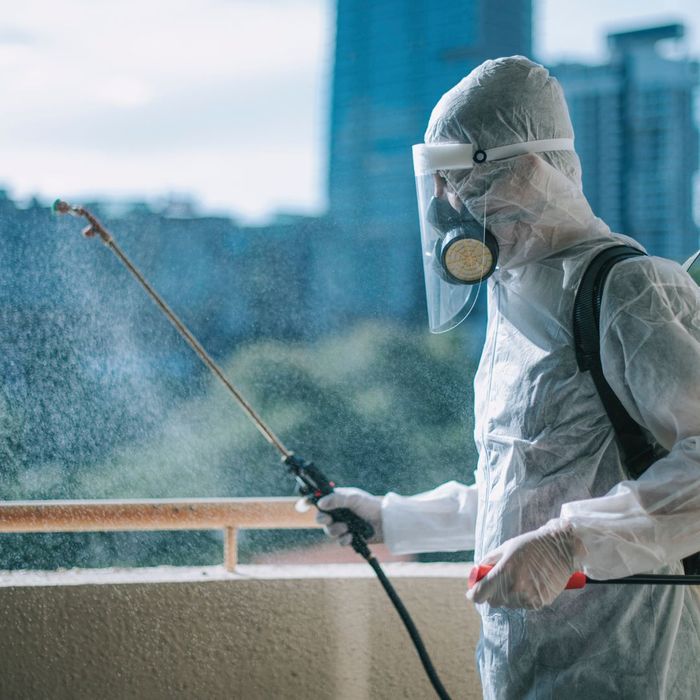 Exterminator spraying pesticides