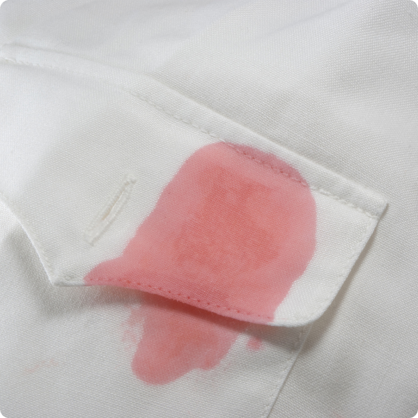 Red wine stain on white shirt.