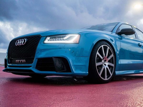A low angle view of the front of a blue Audi