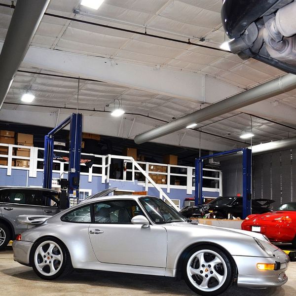 Multiple Porsche's inside repair shop