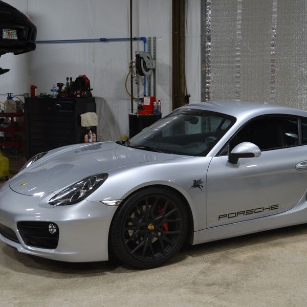 Side view of a silver porsche 
