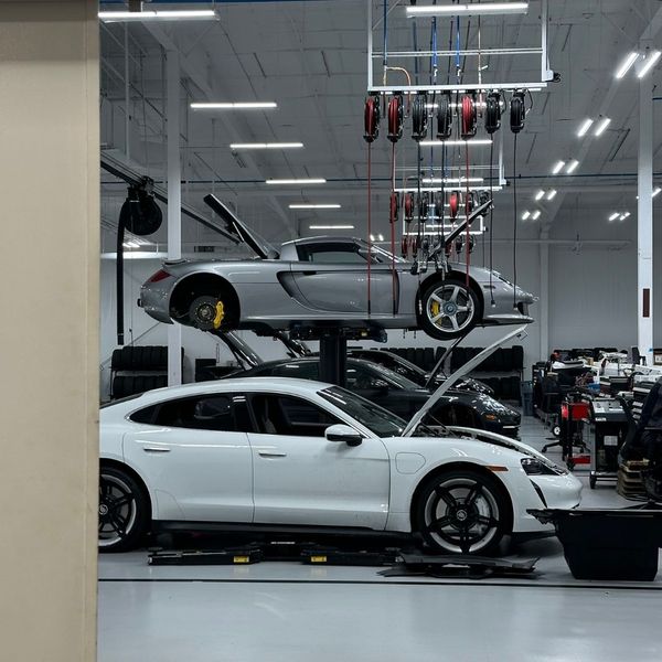 Multiple Porsches in our repair shop with one being lifted