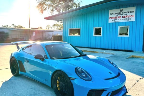 blue GT3 parked outside our building