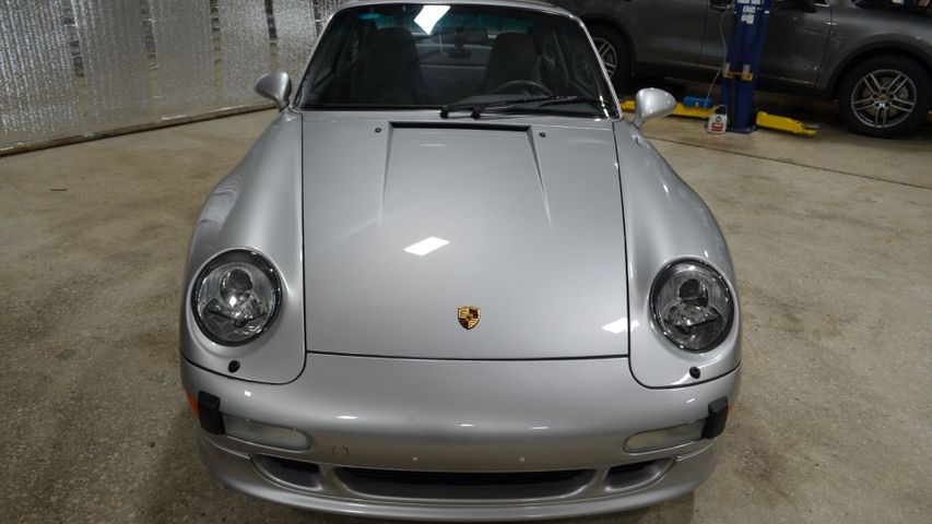 Silver Porsche with hood of the vehicle straight ahead