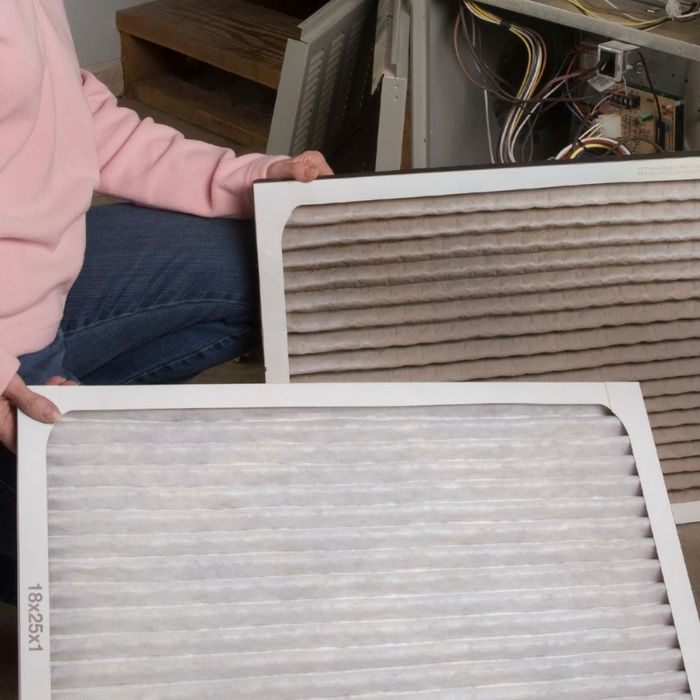 A dirty and clean HVAC air filter next to each other
