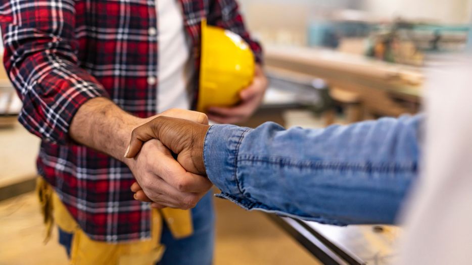 Contractor shaking customers hand