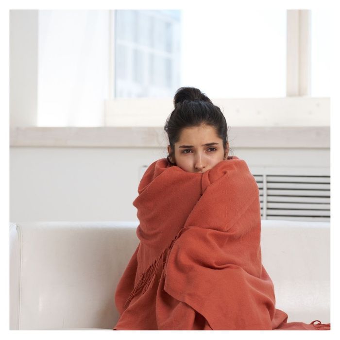 chilly woman wrapped in blanket