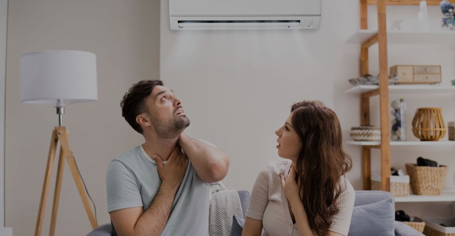 couple looking at AC unit in home