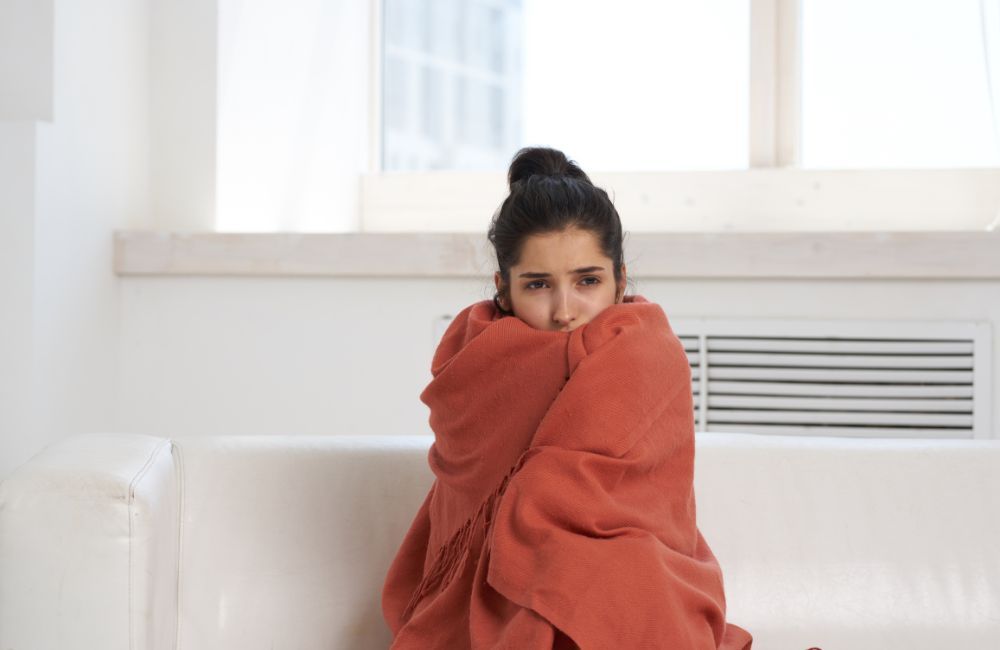 person wearing blanket indoors