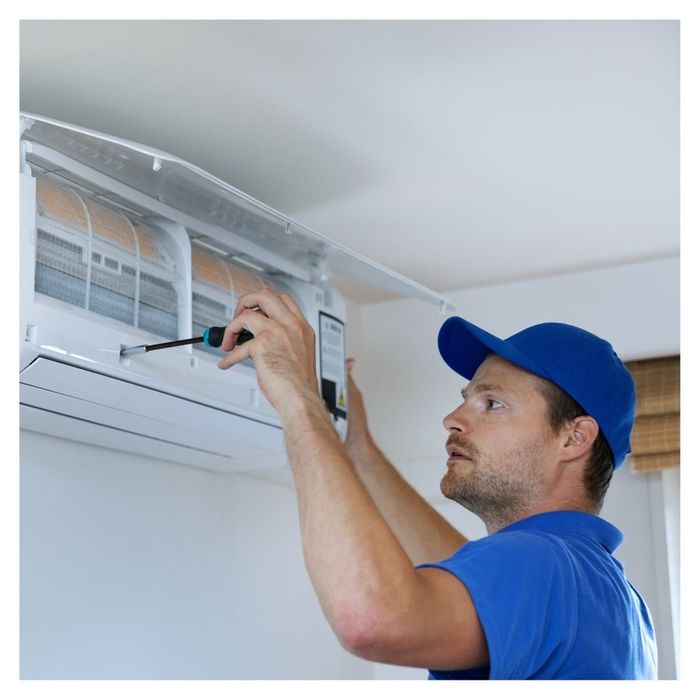 man fixing AC unit