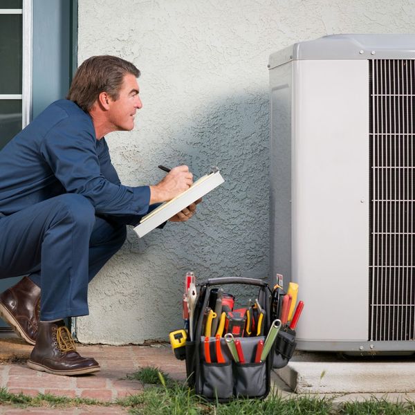 HVAC technician checking out AC