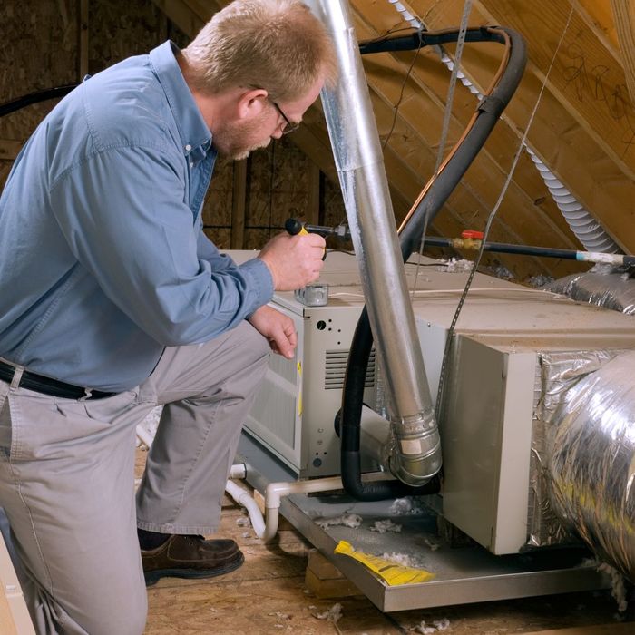 man looking at a heating system