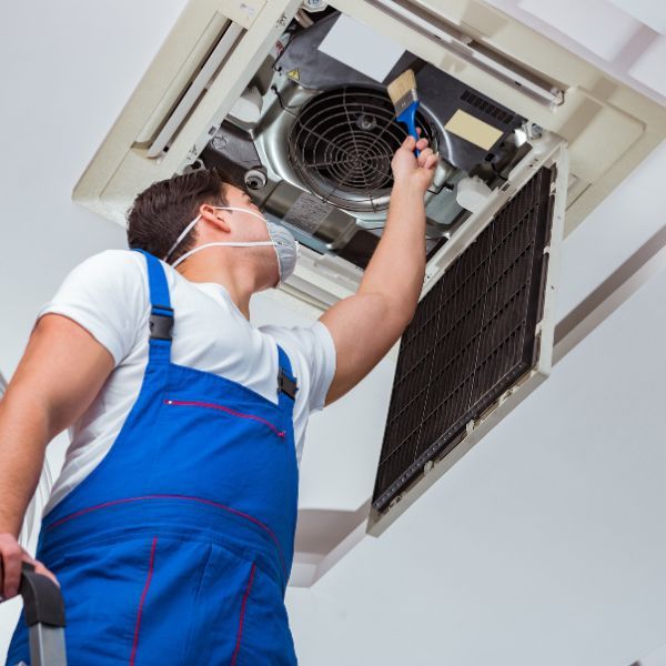 Man cleaning an HVAC system