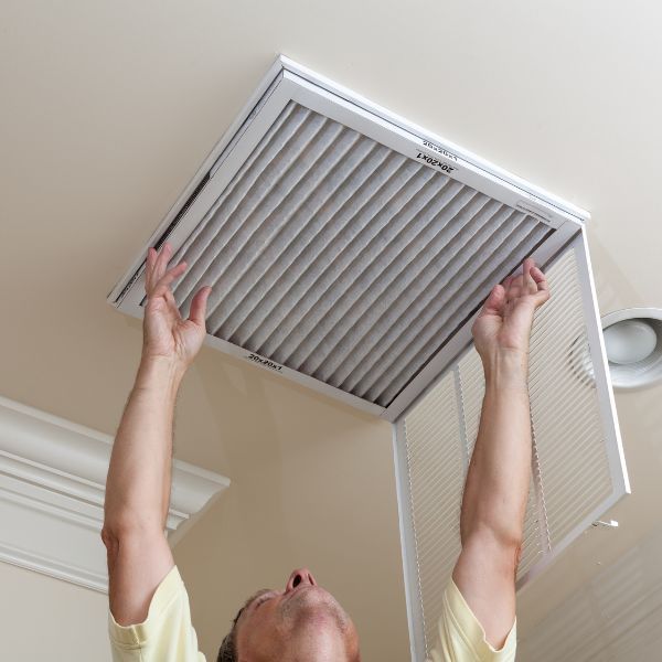 A man changing an air filter
