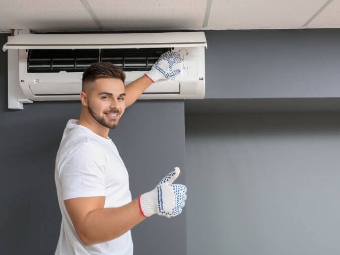 HVAC tech working on air conditioner