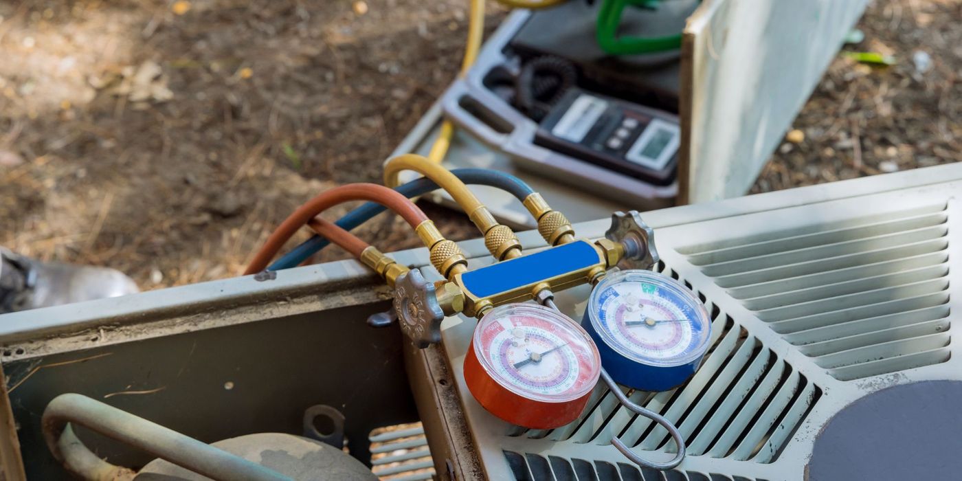 person performing maintenance on ac machine