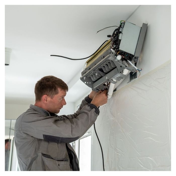 man working on AC installation