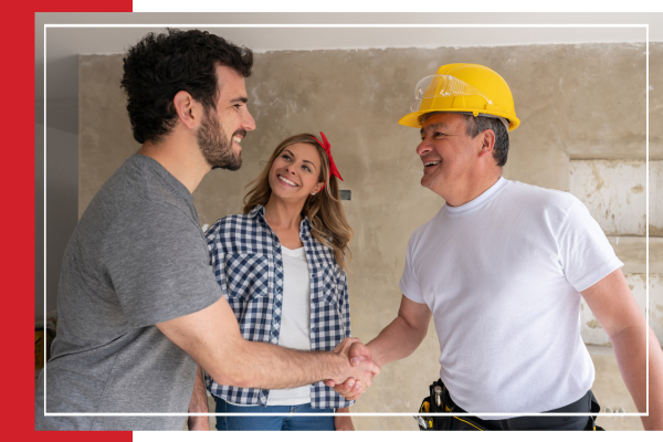 Couple shaking hands with a contractor. 