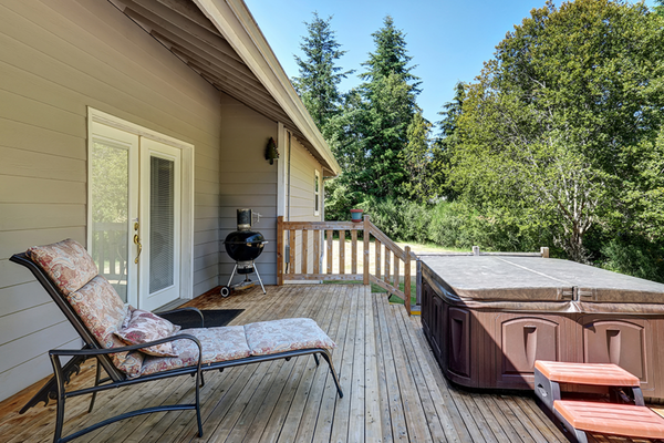 Backyard deck with a hot tub