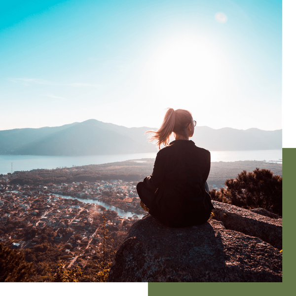 woman sitting in the mountains