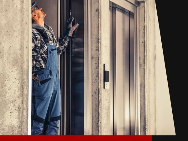 elevator technician inspecting elevator