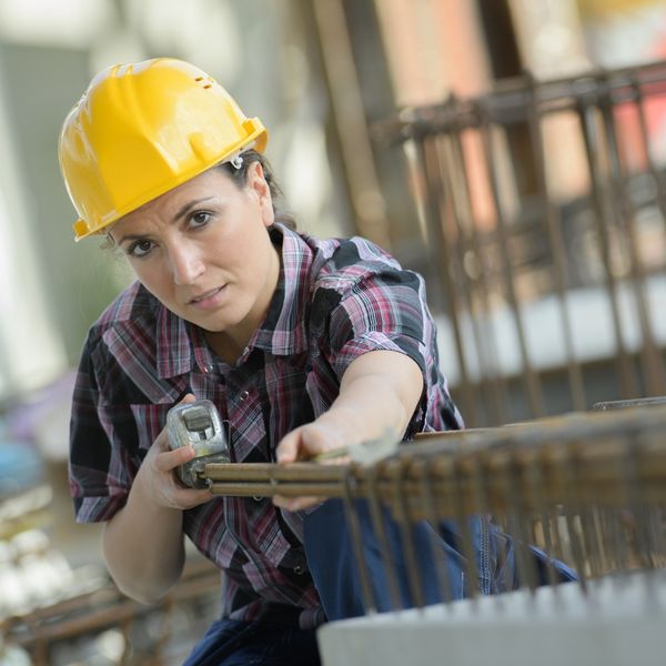 Mechanic working with measuring tape