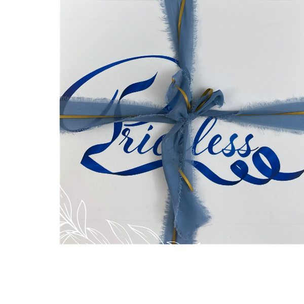 Priceless box secured with blue and gold ribbon