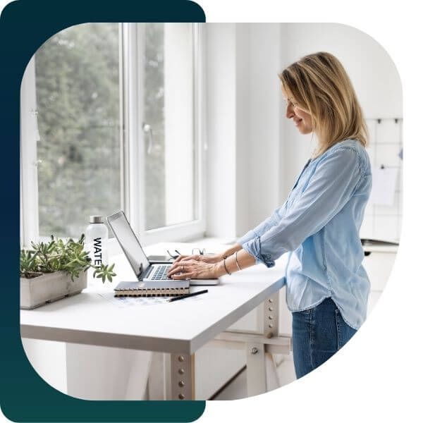 woman at standing desk on a computer