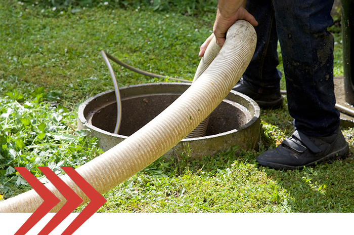 Image of a technician pumping a septic tank