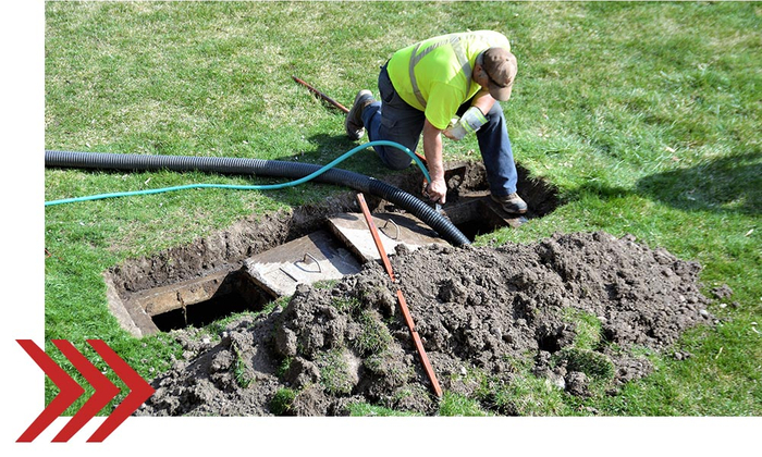 a person cleaning out a septic system