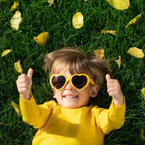 kid laying in grass with thumbs up Engineered Wood Fiber4.jpg