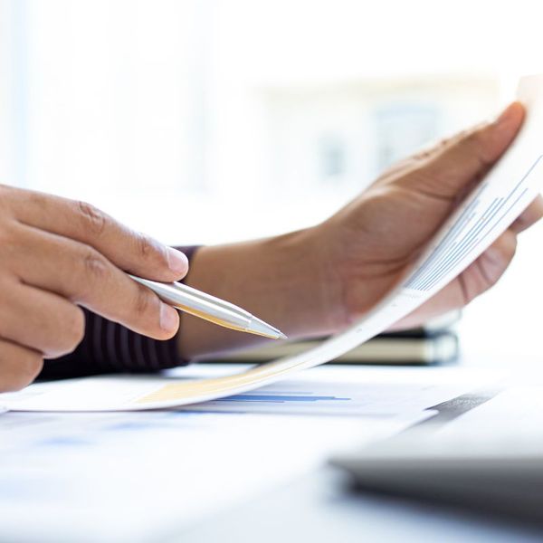 close up of mans hand holding a pen over a report inspections1.jpg